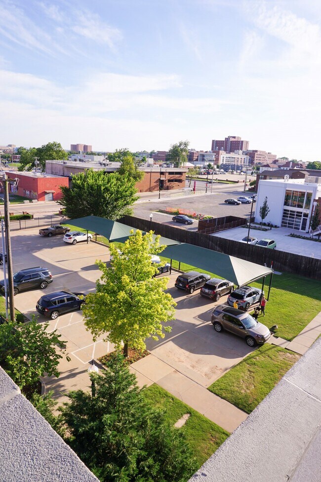 view of covered parking and dog-friendly lawn directly in front of front porch - 1213 N Harvey Ave