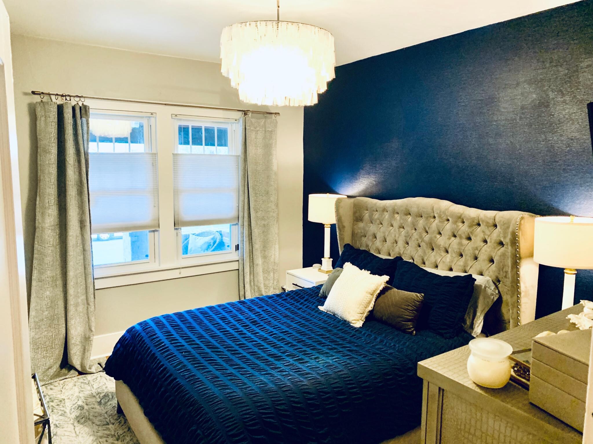 Upstairs bedroom 1 with textured wall paper and high-end light fixture. - 1447 Osceola St