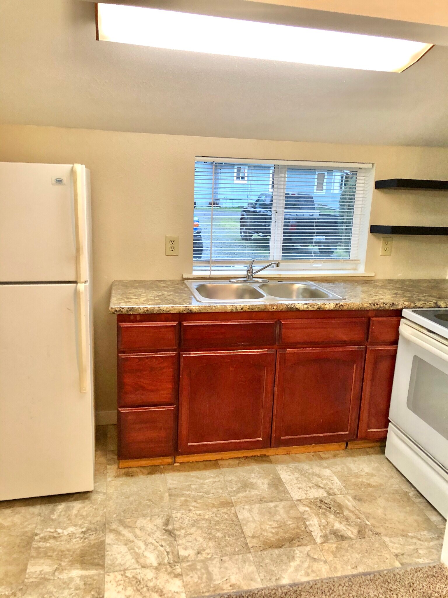 Fully functioning kitchen, stove, refrigerator, new countertops and sink! - 1007 W Main St