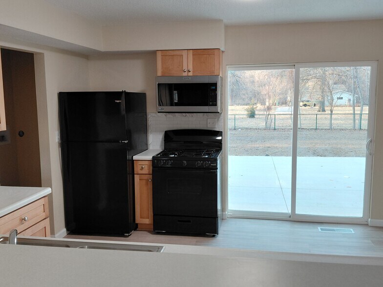 New gas range, new microwave with exhaust vent to outside, and lights used fridge. - 813 Eastmoor Dr