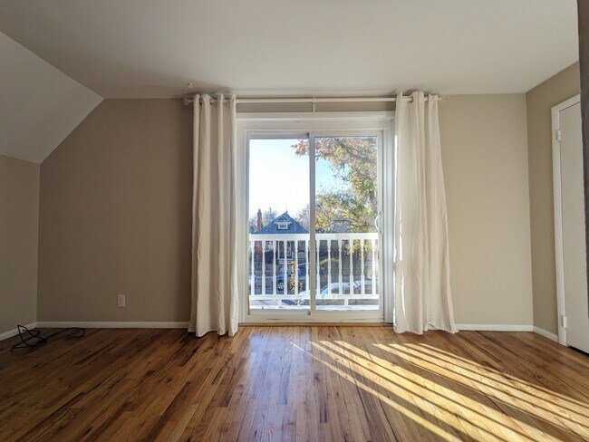 Living room sliding glass doors, to a tiny decorative porch. - 628 S Washington St