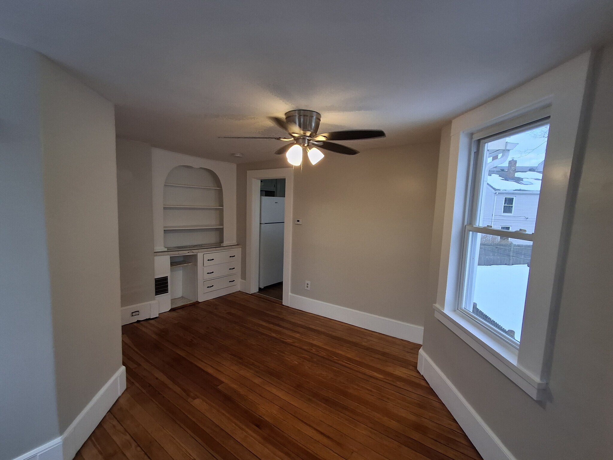 Dining Room: Original built-in shelving unit. The entryway pictured goes to the kitchen. - 13 Mulberry St