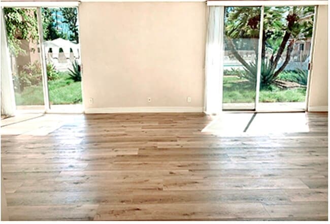 Living room showing both sliding doors in Living Room - 100 S Doheny Dr