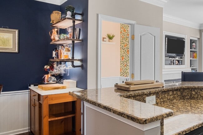 Building Photo - This inviting two-level townhome offers comfort and style, featuring gleaming hardwood floors on ...