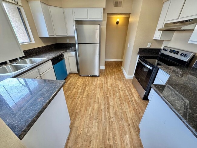 Building Photo - THIS SECOND-FLOOR DESERT SHORES CONDO OFFE...