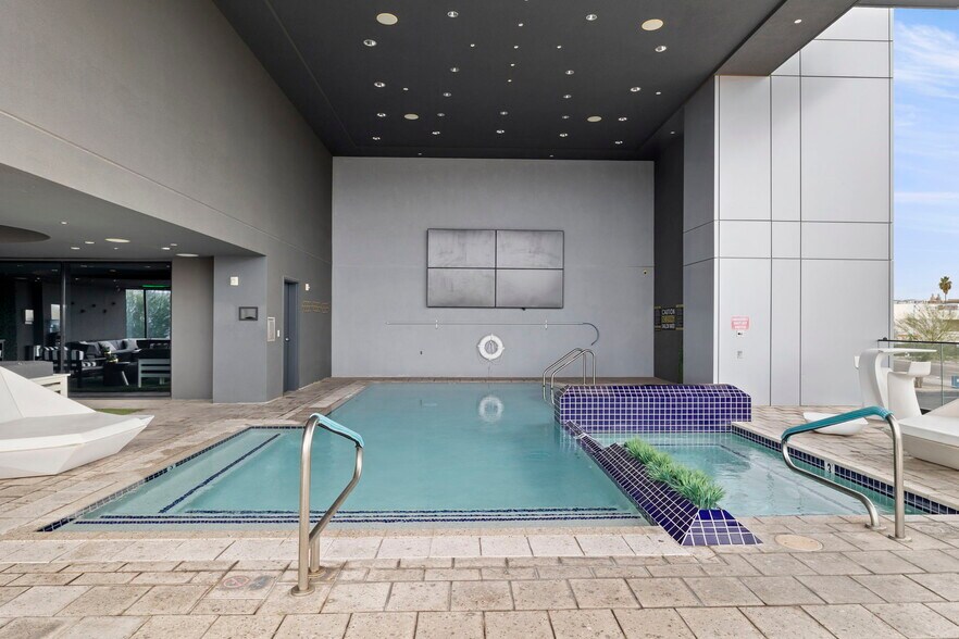 Enjoy sporting events on the split-screen TV wall from the pool or hot tub - 4422 N 75th St