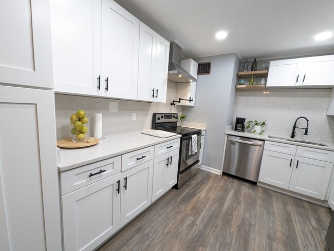 The kitchen has been recently renovated with modern amenities, stainless appliances, a dishwasher, l - 4107 Crane St