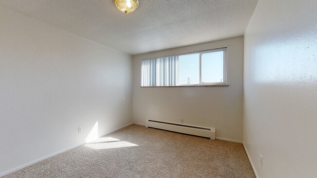 Experience the warmth and light of this inviting bedroom, ready to become your personal sanctuary. - Melody Apartments
