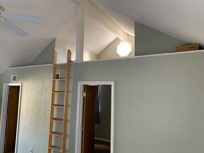 Living room looking up toward loft with ladder - 9356 Lamont St