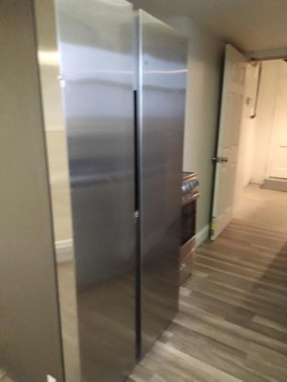 Kitchen area with new refrigerator and stove / back entrance to parking lot - 7525 Forsyth Blvd