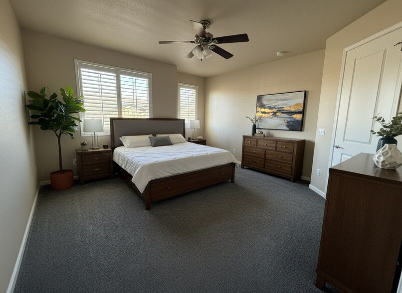 Virtual Staging - primary bedroom with walk-in closet and large bathroom attached - 5580 W 72nd Ave