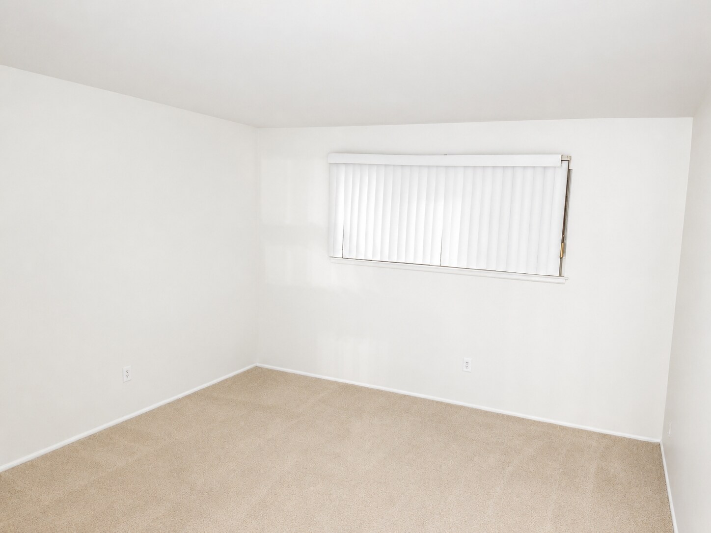 Spacious master bedroom with neutral walls, blackout curtains and a walk-in closet - 339 E Taft Ave