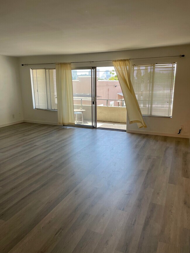 large living room leading to balcony with DTLB views - 1187 E 3rd St