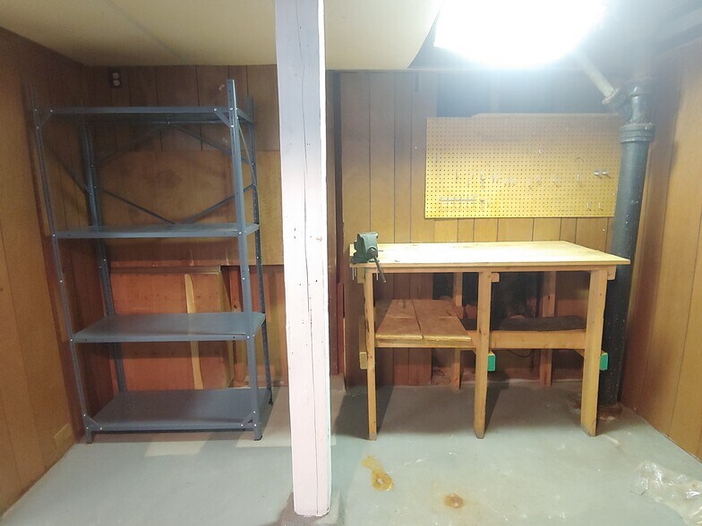 Workbench and shelves in unfinished half of basement. - 7415 1st Ave S