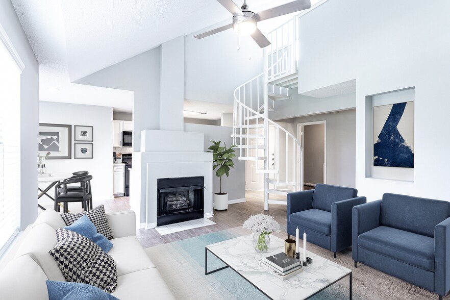 Sophisticated living room with a fire place and spiral loft stairs - Avana Lexington