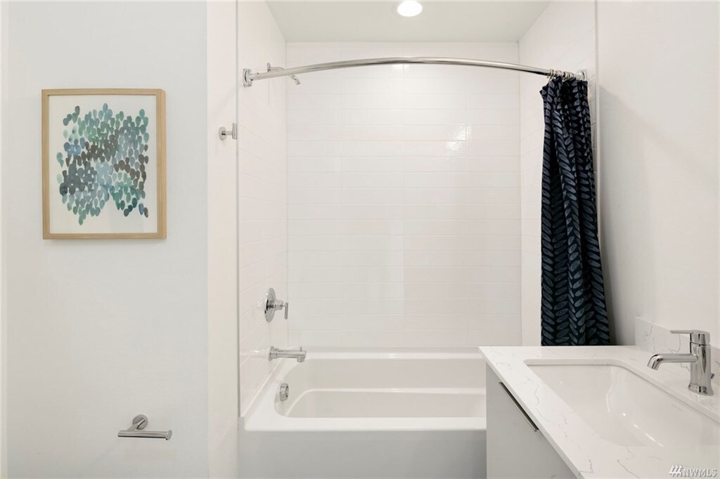 Bathtub and shower in the shared minor bath. - 818 N 47th St