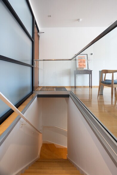 Staircase from kitchen and dining area leading downstairs to the primary bedroom and bathroom. - 2250 11th St NW