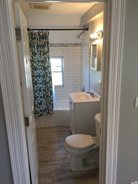 Refreshed and restored bathroom with plenty of storage. - 1927 Washington Street Northeast