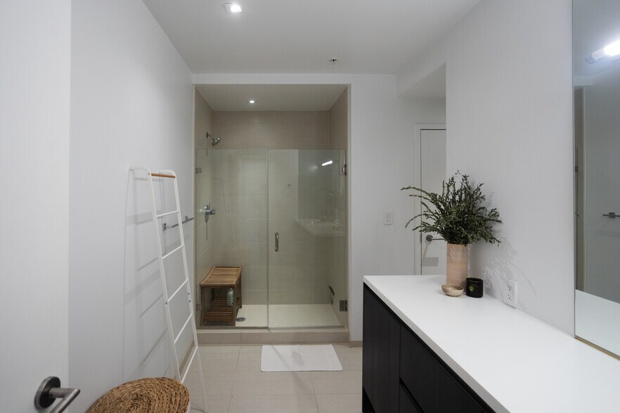 Modernist full bathroom with standing glass and tile shower. Ample counter space and vanity storage. - 2250 11th St NW