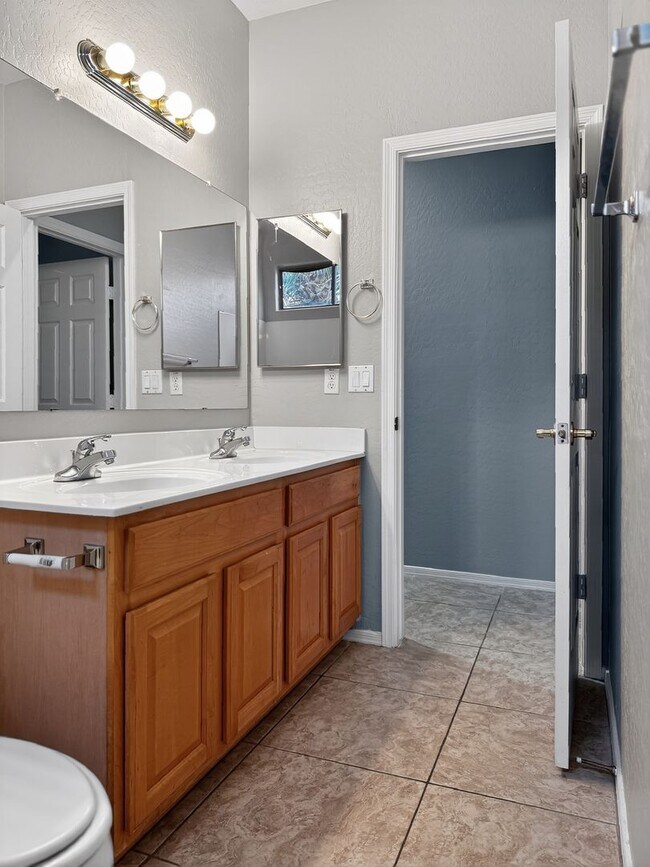 Building Photo - Single-level 4 bed, 2 bath home with tandem 3-car garage and RV gate.