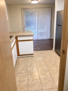 Kitchen view out the sliding door to a deck and backyard. - 24615 104th Ave Ct E