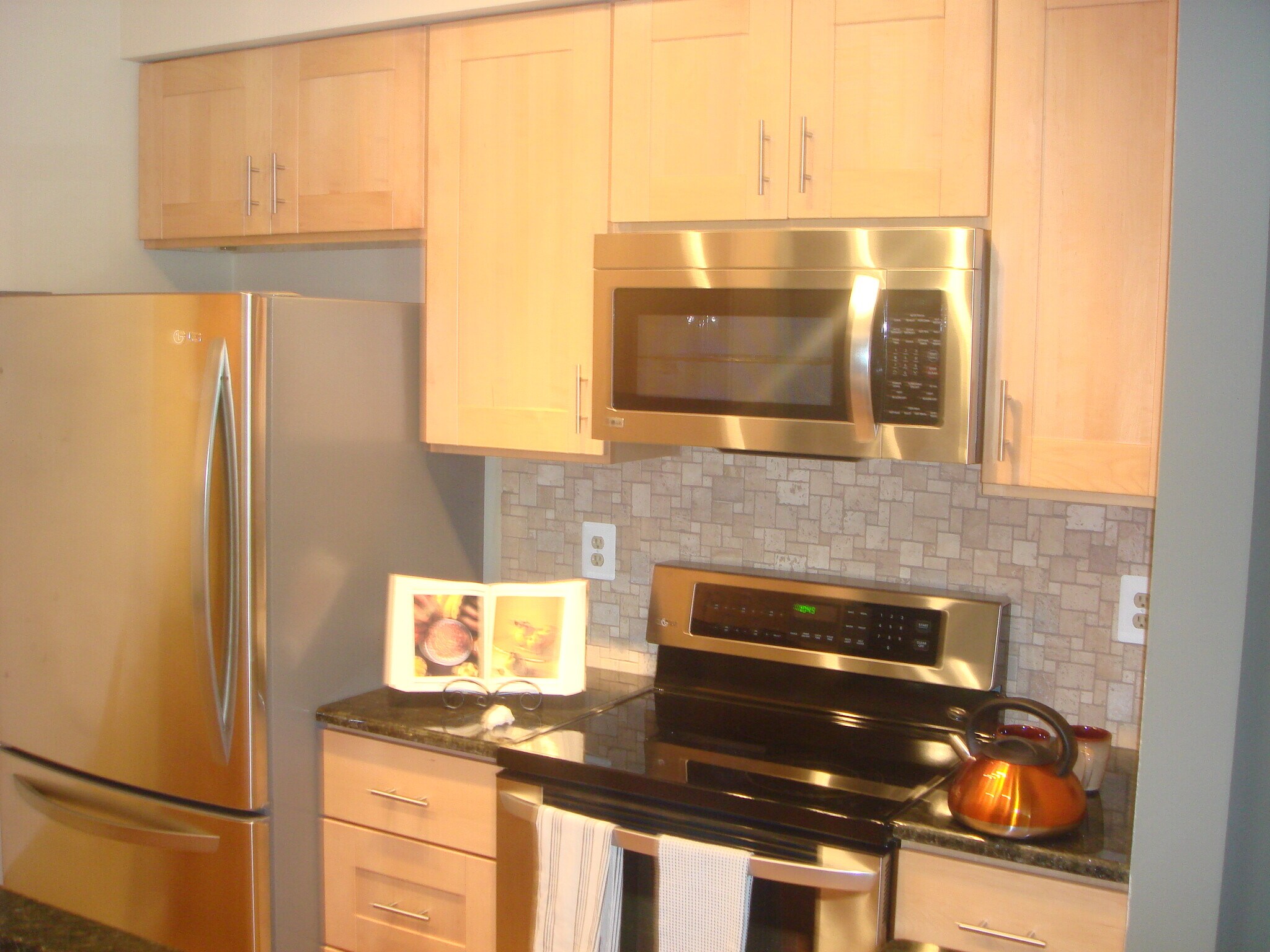 View of kitchen: fridge and stovetop - 5917 Barbados Pl