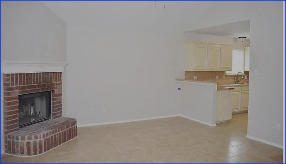 This inviting living room features a charming brick fireplace, perfect for cozy gatherings. - 3108 Silent Creek Trl