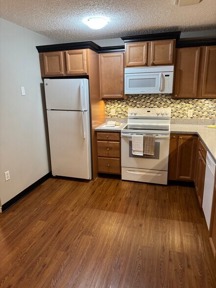 Kitchen includes frost free fridge, glass top five-burner stove, microwave hood, 18" dishwasher - 9 Northbrook Dr
