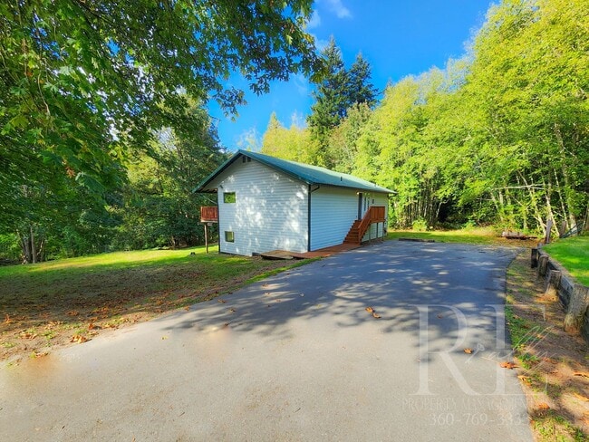 Building Photo - Vaulted Ceilings, Unique Designer Kitchen & Expansive Half-Acre Setting with Flexible Living Spaces