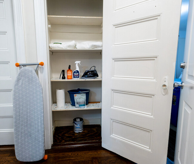 Linen closet with iron board and cleaning supplies - 44 Gibson Pl