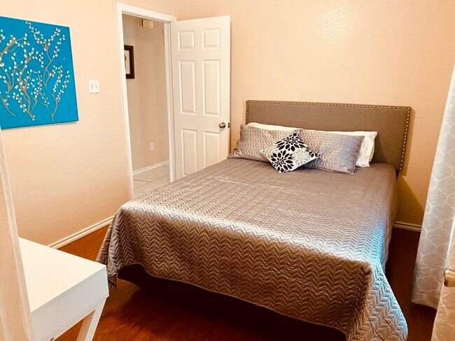 Bedroom 2 large enough for a queen bed and a desk. - 6748 Trail Lake Dr