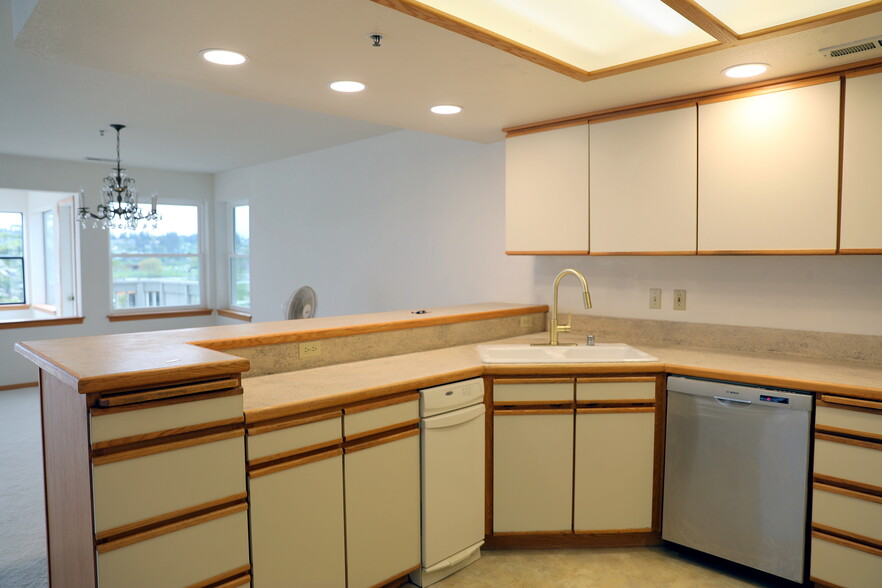 Kitchen open to living room and dining area - 651 SE Bayshore Dr