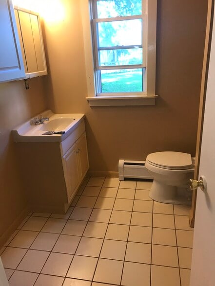 Freshly painted bathroom with connections to your very own washer and dryer. - 122 Dewey avenue
