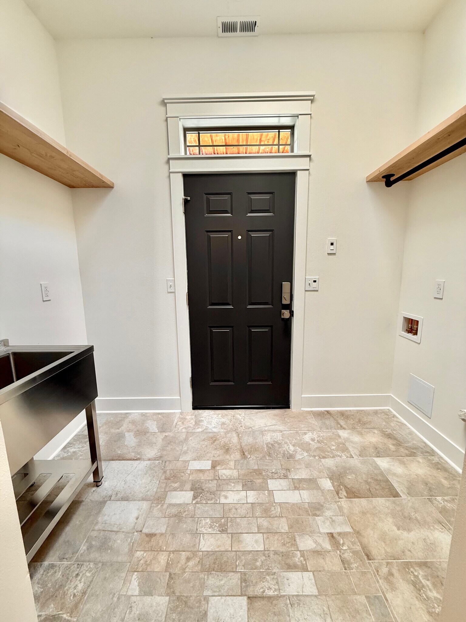 Back alley door, washer dryer hook ups on right. Space to the right has icemaker hookup for a fridge - 24 Ash St N