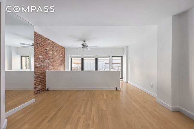 Building Photo - Loft-style one-bedroom with double-height ceilings, oversized windows, and private garden in the ...