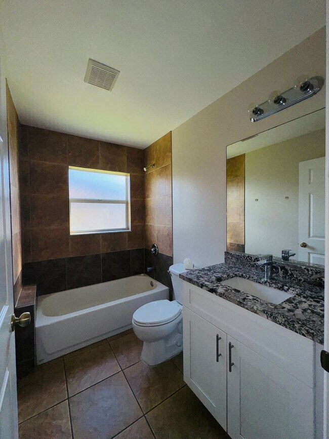 Building Photo - Experience this Cape Coral 3 bedroom 2 bath corner duplex with 1 car garage and screened in lanai.