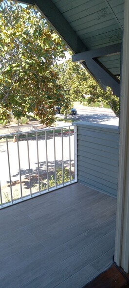 Upstairs porch with sitting area and electrical outlets. - 1135 Magnolia St