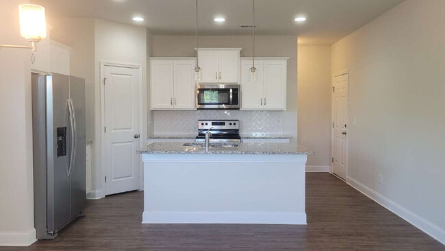 Building Photo - "Spacious 4-Bedroom Retreat with Modern Gr...