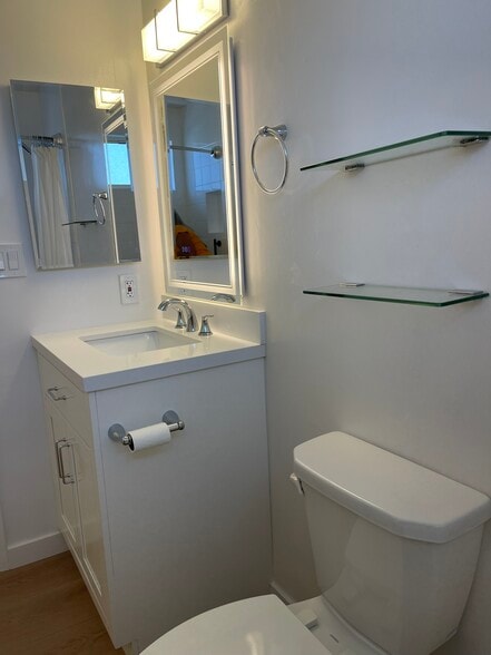 These pictures don't do the bathroom justice! Much brighter in person. Note front/backlit mirror. - 1039 6th St