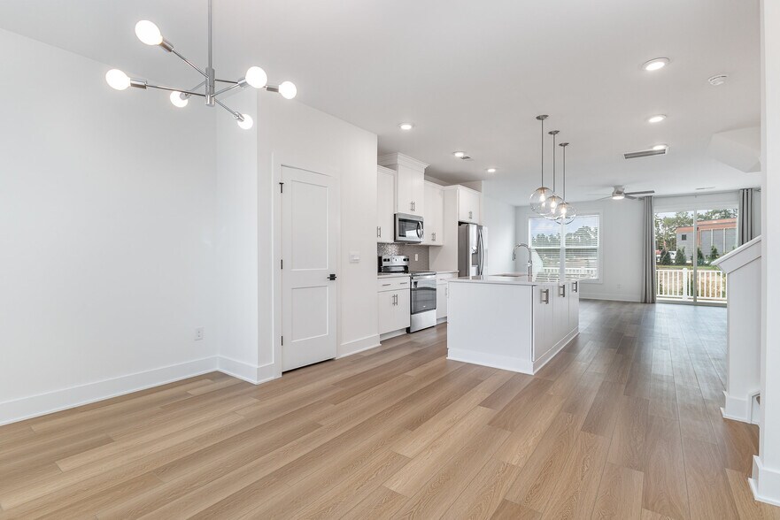 Dining area overlooking huge kitchen with quartz island toward the family room - 514 Billingshurst Way