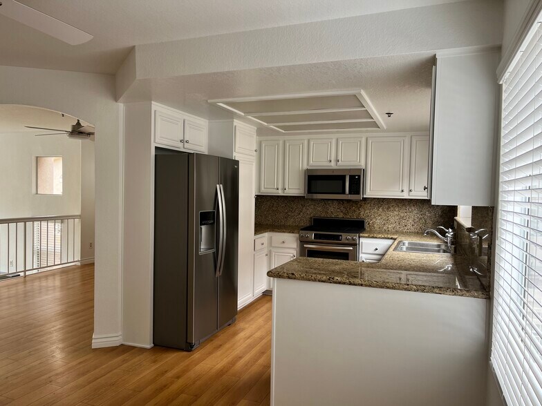 Dining area and kitchen with brand new refrigerator - 1345 E Grand Ave