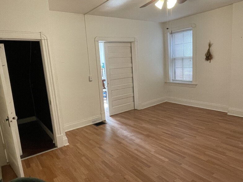 Large middle room. Featuring a pocket door to the front room & large walk-in closet. - 5313 Magnolia Ave