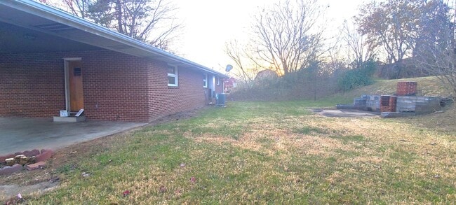 Building Photo - HALF OFF FIRST MONTH RENT! Single family brick home with full unfinished bsmt & detached garage