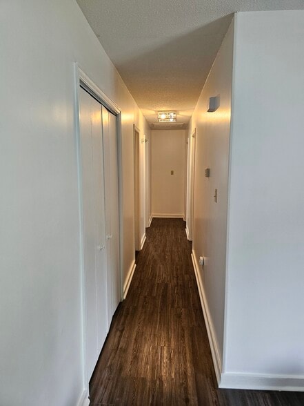 Hallway has double door closet for ample storage - 404 Rams Rd