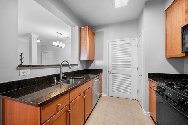 Building Photo - Two-bedroom, two-bathroom model with a den, located on the third floor.