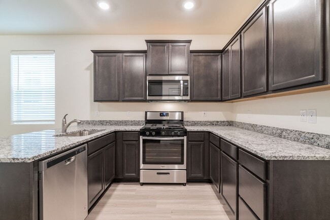 Building Photo - Super clean & spacious 4-bdrm/3-bath townhome in NE—Attached garage, great location