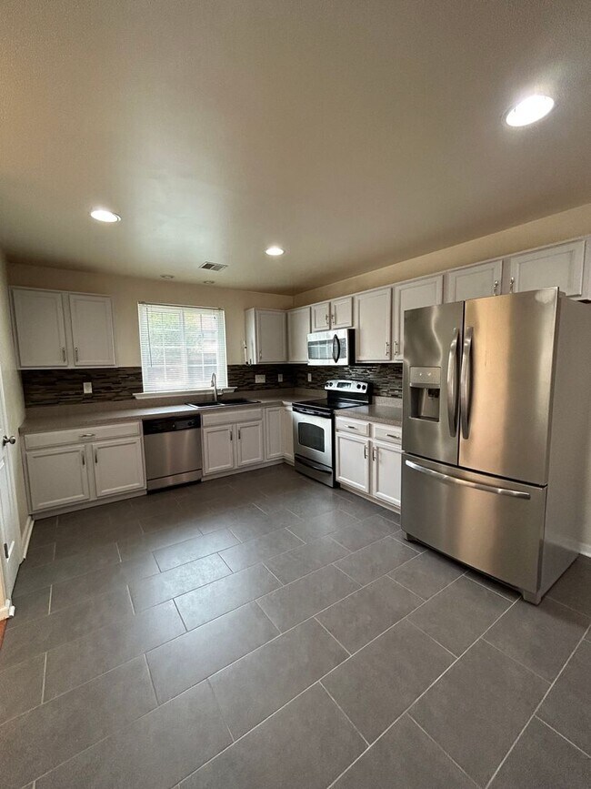 Building Photo - Space, Style - Move-In Ready 4-Bedroom End Unit with Finished Basement & Garage