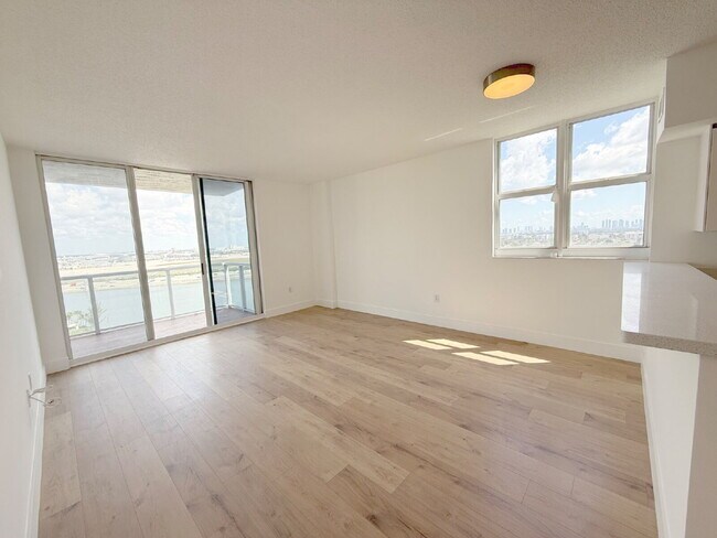 Building Photo - Rare 2/2 Corner Penthouse with Panoramic Lagoon Views from Every Room – Available Now!