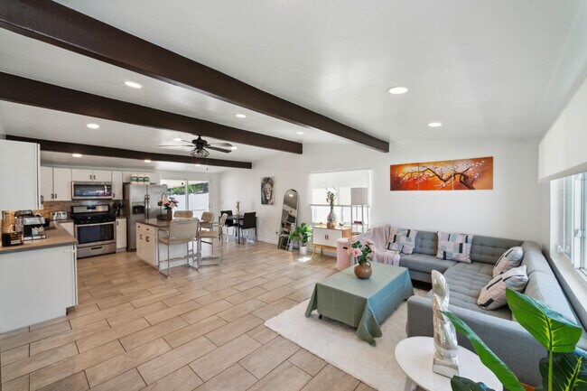 Living room with easy access to the kitchen, perfect for seamless entertaining! - 9853 Saint George St