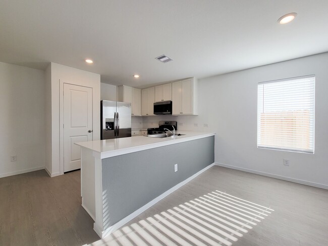 Building Photo - This single-level home showcases a spacious open floorplan shared between the kitchen, dining are...